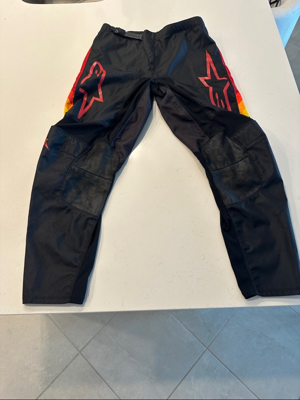 Alpinestars Black Motocross Pants with Red and Yellow Side Logos